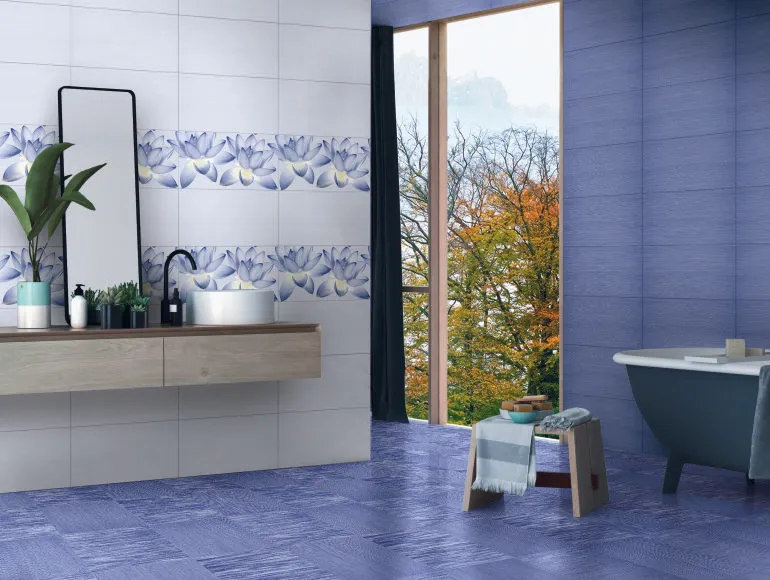 Blue bathroom design with a sleek bathtub, wall mirror and large window